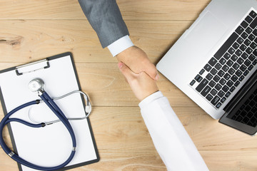 Wall Mural - Doctor and businessman shaking hands