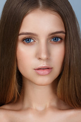 Wall Mural - Close-up portrait of sexy young woman with beautiful blue eyes. Woman beauty face portrait with healthy skin. Portrait of beautiful young woman looking at camera. Natural beauty concept