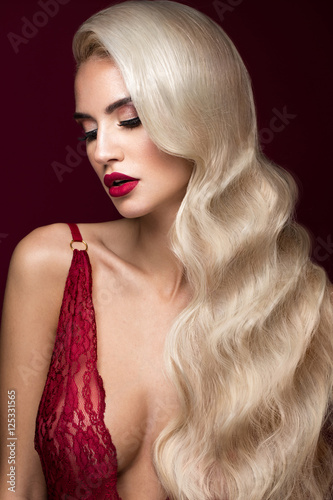 Poster Beautiful blonde in a Hollywood manner with curls, red lips, red lingerie