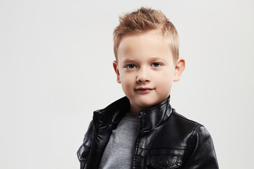 Fashionable child in leather coat.stylish little boy with trendy haircut