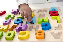 Two Year Old Child Playing With Letters