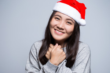 Happy woman wearing a santa hat on isolated background