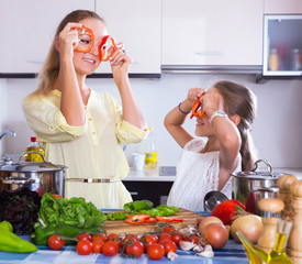 Wall Mural - Girl helping mother to prepare