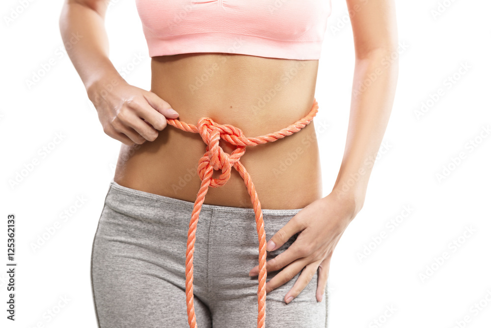 Woman's abdomen tied with a rope, conceptual
