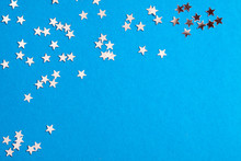Frame Of Scatters Little Silver Stars On Blue Background.