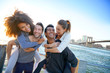 © goodluz - Group of friends enjoying sunset on Brooklyn heights promenade, NYC