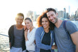 © goodluz - Group of friends enjoying sunset on Brooklyn heights promenade, NYC
