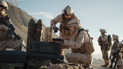 Wall Mural - Soldiers are Using Laptop Computer for Surveillance During Military Operation in the Desert. Slow Motion.