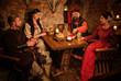 © Nejron Photo - Medieval people eat and drink in ancient castle tavern
