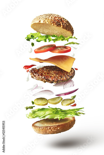 Cuadros en Lienzo Delicious hamburger with flying ingredients