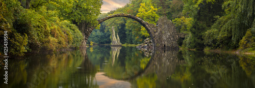 Autumn over Devil's bridge in the park Kromlau, Germany
