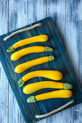 Wall Mural - Fresh yellow zucchini on wooden cutting board