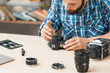 © golubovy - Disassembling of photo camera, close-up. Photographing equipment maintenance and repair. Hobby, occupation, business
