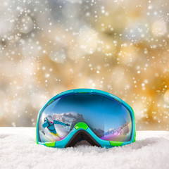 Ski goggles with reflection of winter mountains.