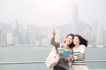 Canvas Print - two beauty woman take map