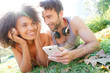 © goodluz - Couple at Central park listening to music on smartphone
