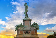 Side view of bronze cast statue of David at Michelangelo Square (Piazzale Michelangelo) on hill in evening during sunset, Florence, Italy 