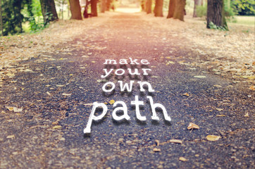 Make your own path. Motivational quote to create future on nature background.