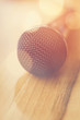 Closeup detail of a microphone with bokeh lights. Soft focus.