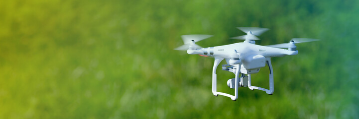 Quadcopter drone flying over a cultivated field