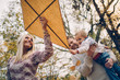 © chika_milan - Dad, mom and son  flying a kite in nature