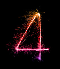 4.digit four made of firework sparklers at night