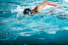 Young Man Swimming The Front Crawl In A Pool