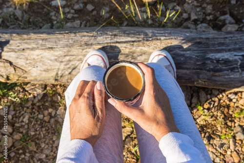 Plakat Adult woman is enjoying morning coffee in nature
