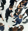 © ASDF - Elevated view of large group of multiethnic business people maki