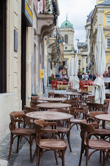 Empty tables of outdoor cafe in city center of Lviv, Ukraine in Europe