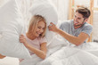 © Yakobchuk Olena - Carefree loving couple having fun with cushions