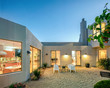 © coralimages - Modern Mediterranean home exterior at twilight.