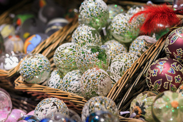 Colorful close up details of christmas fair market. Balls decora