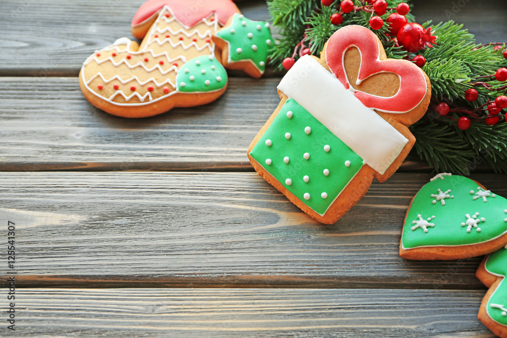Tasty gingerbread cookies on wooden background, close up