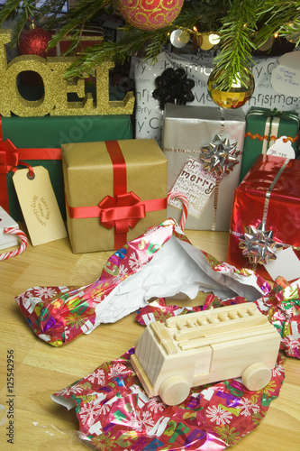 Fotografia, Obraz Wooden Fire Engine Christmas present unwrapped under a xmas tree