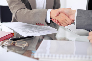 Wall Mural - Business handshake. Two women lawyers are shaking hands after meeting or  negotiation.