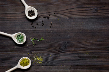 Wall Mural - spices for cooking in spoon on wooden table top view