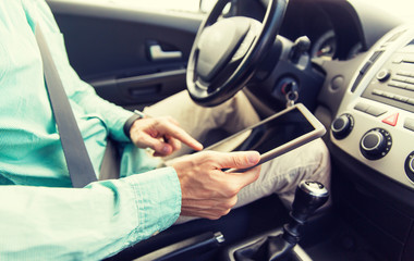 Poster - close up of young man with tablet pc driving car