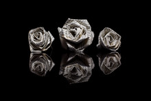 Three Paper Roses Made From Book Pages Isolated On Black Backgro