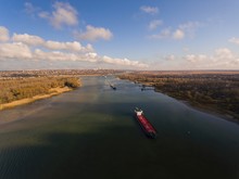 Cargo Ship In Beautiful River. Aerial View. Autumn Landscape.    