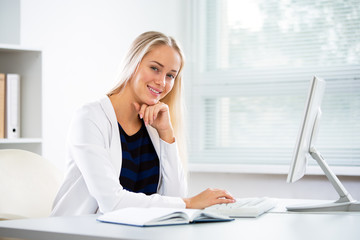 Wall Mural - Young business woman with computer