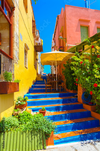 Cozy small Cretan cafe and colorful stairs between nice Cretan houses in Rethymnon, Island Crete, Greece © Zakhar Marunov