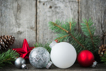Wall Mural - red, silver and white xmas ornaments on rustic wood background. merry christmas card. winter holiday