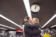 Senior couple at the underground platform, hugging and kissing