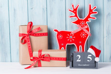 Christmas Decorations With Gift Boxes, Block Calendar And Deer, Wooden Background