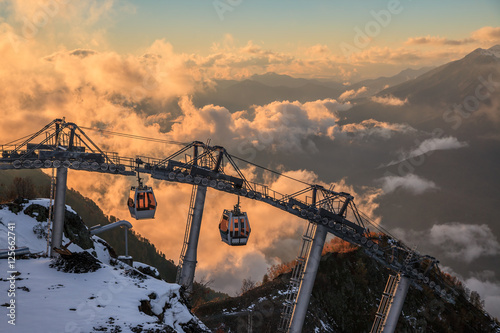 Cableway Lift Gondola Cabins On Cloudy Mountain Sunset Background