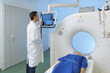 © s4svisuals - Radiologic technician and Patient being scanned and diagnosed on