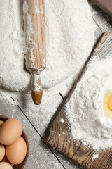 Poster - Rolling pin with flour and eggs close up, top view