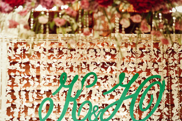 Wall Mural - Green letters hang on the wall with light garlands