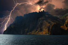 Thunderstorm And Lightning On The Black Sea Shore, Crimea /Lightning Over The Coast Of The Black Sea. Rocky Coast Of The Eastern Crimea. Near Koktebel. The Power And Energy